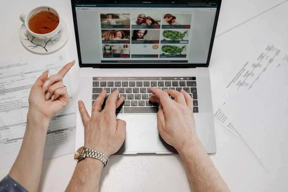 Two business professionals analyzing market trends on digital devices in an office setting.